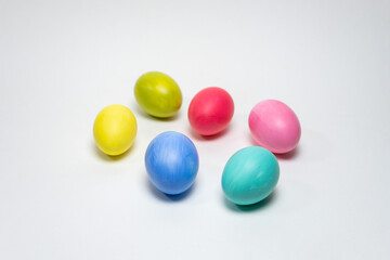 Six colorful eggs on white background. Selective focus. Creative Easter background
