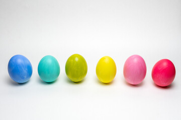Six colorful eggs on white background.  Standing up. Creative Easter background
