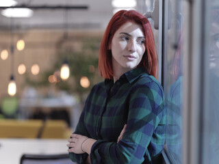 redhead business woman portrait in creative modern coworking startup open space office