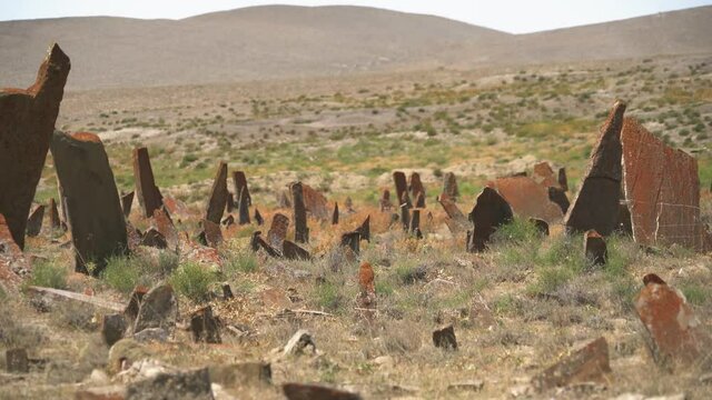 Tombstones and obelisks in the prehistoric cemetery.Anthropomorphic kurgan stone stelae statue menhirs steles ancient monument.Menhir orthostat lith old bronze age megalith Stele mass graveyard grave 