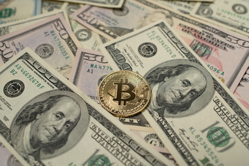 Golden Bitcoin on top of Dollar Banknotes. Digital Crypto currency and fiat Money. US Dollar Cash. USD Background and BTC coin in center
