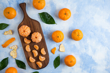 Top view. Pile of mandarins whole and peeled