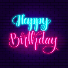 Happy birthday. Glowing pink and blue neon incription on dark brick wall background.