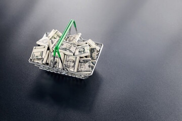 Dollars symbol in basket, concept of success, inflation and helicopter money, with copy space on dark background