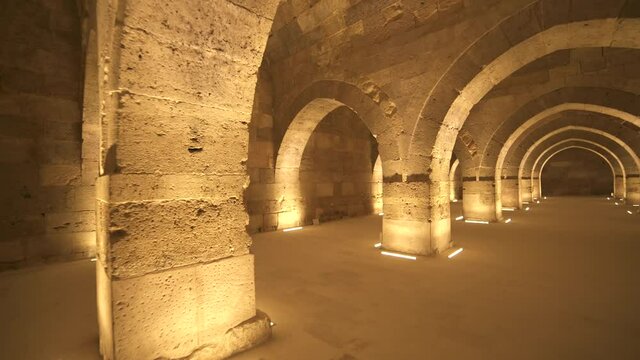 Interior of historical building with stone arches and domes.Cathedral minster church sultan Han caravanserai caravansary khan wikala funduq medieval architecture caravanserais niche courtyard detail.