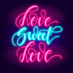Love sweet love. Glowing pink neon incription on dark brick wall background.