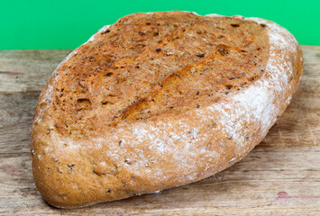 oval loaf of dark bread made from several types of flour