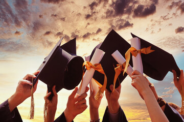 International students in mortar boards and bachelor gowns with diplomas. - 424612633