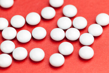 medicines for the treatment of diseases scattered on a red background