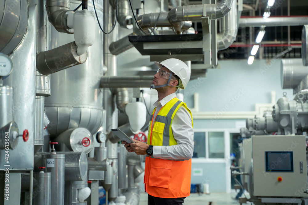 Poster engineer checking and maintenance technical data of system equipment condenser water pump and piping