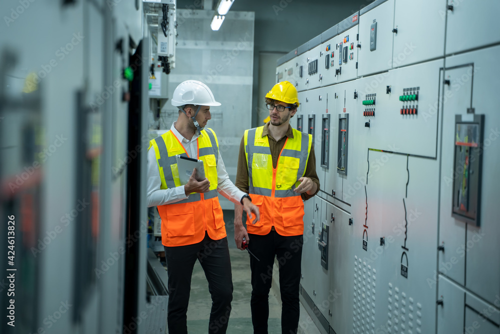 Poster engineer and technical worker working on the checking status switchgear electrical energy distributi