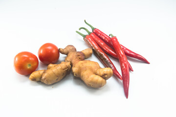 chilli,ginger and tomato on a white background.