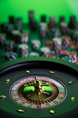 Casino. Gambling games theme.  Roulette wheel, dice and poker chips on the casino felt green table.