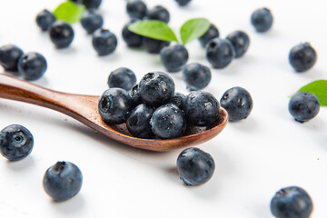 Fresh blueberry with drops of water on white background