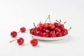Obraz na płótnie Canvas Cherry berries fruit in a plate on white background.Close-up. 