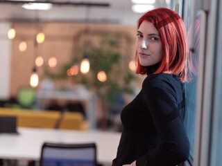 Fototapeta premium redhead business woman portrait in creative modern coworking startup open space office