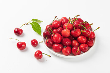Cherry berries fruit in a plate on  white background.Close-up. 