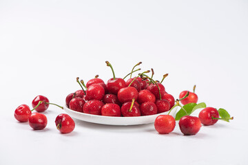 Cherry berries fruit in a plate on  white background.Close-up. 
