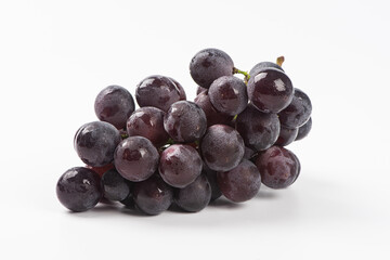 a bunch of purple grapes isolated on white background