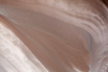 Snowpack with lines and curves structure on a house eave after a storm