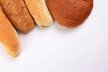 Freshly baked bread loaf bun roll round long mix verity copy text space border frame white background