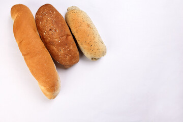 Freshly baked bread loaf bun roll round long mix verity copy text space border frame white background