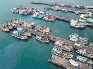Aerial view of fisherman dock which has many ships anchoring for transport seafood and supplies inland