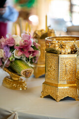 Gold decorative ornaments used in a Cambodian wedding wiith flowers