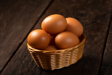Basket with brown chicken eggs goes up the table.