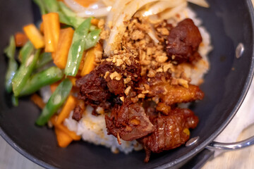 Rice with adobo chicken toppings