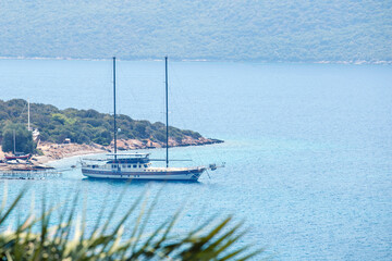 Turquoise sea and sailboat moored. Summer vacation concept.