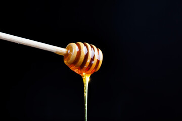 a spoon for honey together with high-quality bee honey