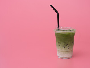 Iced Green Tea with ice on pink background