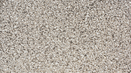 Wall texture formed by small stones of light and dark color.