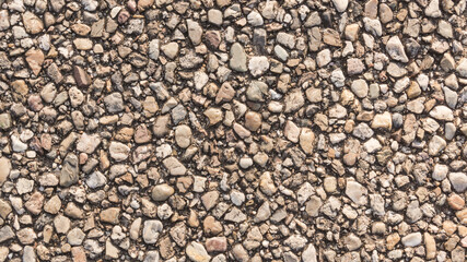 Textured wall formed by small stones for background. 
Textura de pedra em tela cheia 