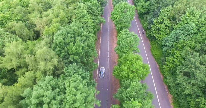 Droneshot of a tuned Ford Focus ST accelerating on an abandoned road.