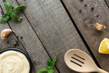 Making garlic cream sauce, cooking cheese sauce. Seasonings on wooden background