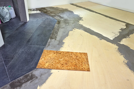 Cork floor tiles ready to install in bathroom on the waterproofed subfloor