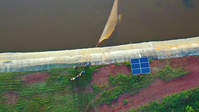Fish farmers netting their fish in Africa. Shot on a canon eos r and 70-200 f2.8.