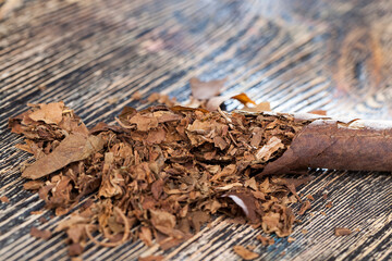 tobacco from a crumbling cigarette on the board