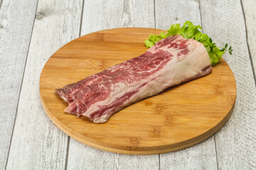 Raw beef bacon over wooden board
