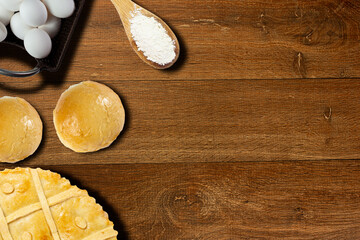 Fototapeta na wymiar Topview of a rustic wooden table with pie, eggs, bread 