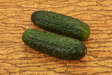 Green fresh cucumbers over background