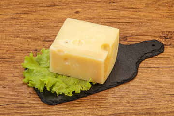 Emmental cheese over wooden board