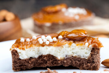 tartlet with milk cheese filling and lots of salted caramel with nuts