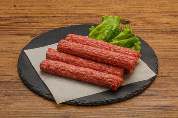Raw beef sausages with spices