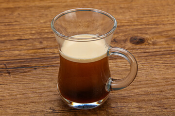 Hot Espresso coffee over wooden table