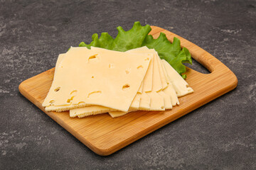 Sliced yellow cheese over board