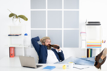 Tired bored businessman yawning at workplace near laptop, boring work, dead end job, overwork extra...