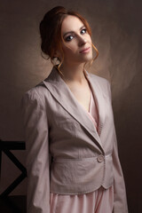 young beautiful Caucasian woman, in a pink dress and jacket